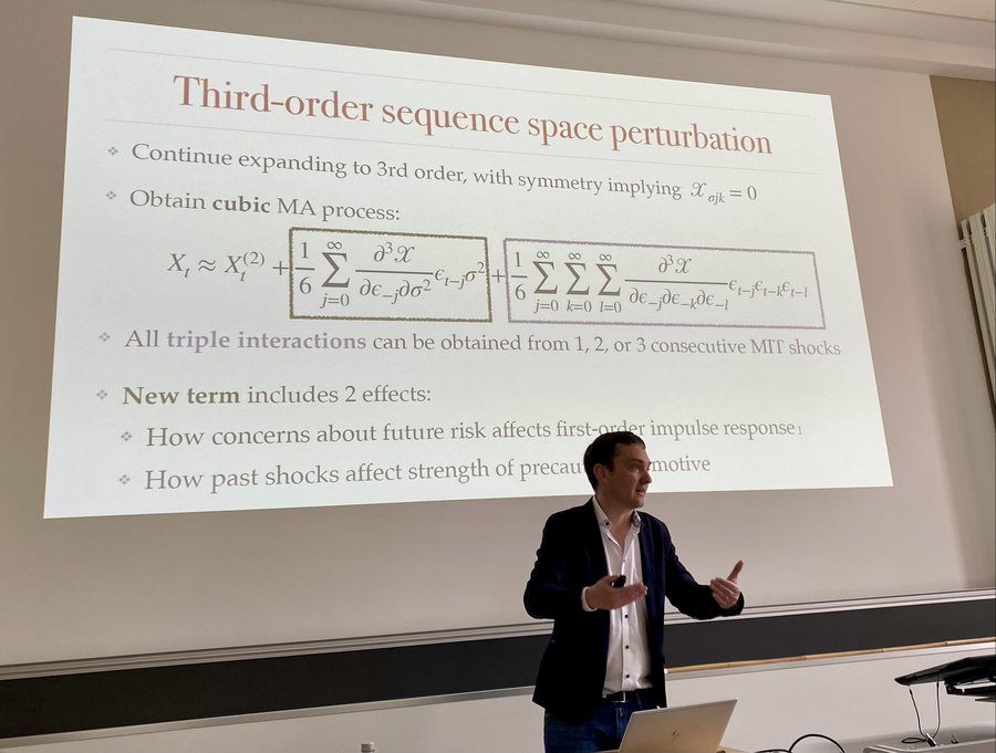 Adrien Auclert (Stanford) presented “Beyond Certainty Equivalence: Higher-Order Perturbations in the Sequence Space” with Rigato, Rognlie & Ludwig Straub. They extend the influential sequence-space Jacobian approach beyond the 1st order, enabling study of new questions in HA macro